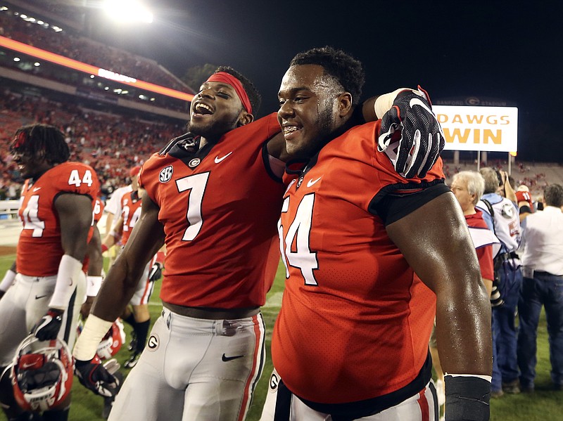 
              Georgia running back D'Andre Swift (7) and offensive lineman Justin Shaffer (54) leave the field after Georgia defeated Missouri 53-28 in an NCAA college football game Saturday, Oct. 14, 2017, in Athens, Ga. (AP Photo/John Bazemore)
            