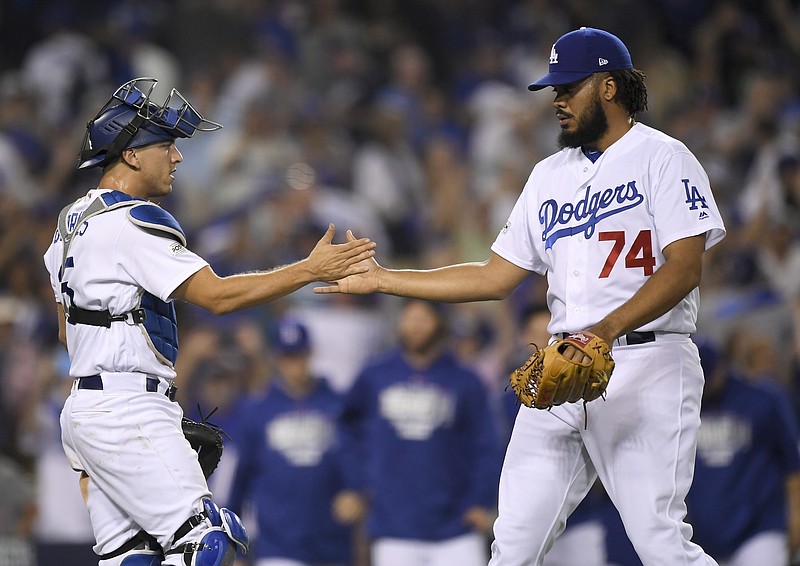 
              Los Angeles Dodgers relief pitcher Kenley Jansen, right, celebrates the team's 5-2 win with catcher Austin Barnes after Game 1 of baseball's National League Championship Series against the Chicago Cubs in Los Angeles, Saturday, Oct. 14, 2017.(AP Photo/Mark J. Terrill)
            