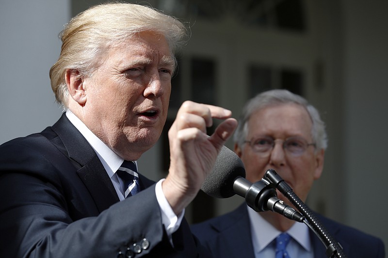 
              President Donald Trump answers questions as he speaks with Senate Majority Leader Mitch McConnell of Ky., in the Rose Garden after their meeting at the White House, Monday, Oct. 16, 2017, in Washington. (AP Photo/Alex Brandon)
            