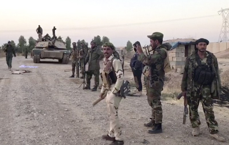 
              This image made from a video shows Iraqi soldiers in the Qatash area towards Kirkuk gas plant, south of Kirkuk, Iraq, Monday, Oct. 16, 2017.  Iraqi state media say federal troops have entered disputed territories occupied by the nation's Kurds. The move comes three years after Kurdish militias seized the areas outside their autonomous region to defend against an advance by the Islamic State extremist group. (APTN via AP)
            