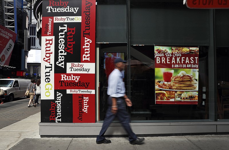 
              In this Friday, Sept. 16, 2016, photo, a man walks by a Ruby Tuesday restaurant in New York's Times Square. Ruby Tuesday is being bought by private-equity firm NRD Capital, in a deal that will take the struggling restaurant chain private. Like other sit-down restaurant chains, Ruby Tuesday has had a hard time attracting diners who are increasingly eating at cheaper, faster and more casual places. (AP Photo/Mary Altaffer)
            