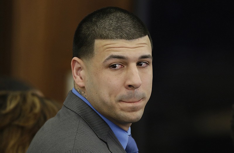 
              FILE - In this April 14, 2017, file pool photo, former New England Patriots tight end Aaron Hernandez turns to look in the direction of the jury as he reacts to his double murder acquittal after the sixth day of jury deliberations at Suffolk Superior Court in Boston. Football helmet maker Riddell says it intends to vigorously defend its products and its reputation against concussion-related lawsuits like one lawyers for late Hernandez have filed in Massachusetts against it and the NFL. Hernandez's attorneys filed a federal lawsuit last month after Hernandez killed himself in prison and an autopsy revealed he had chronic traumatic encephalopathy, a brain disease found in people who've suffered repetitive brain trauma such as concussions. The lawsuit was refiled Monday, Oct. 16. (AP Photo/Stephan Savoia, Pool)
            