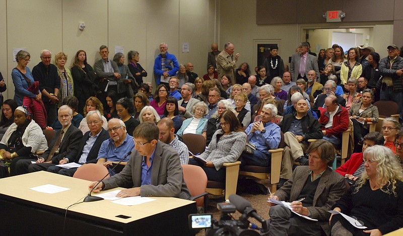 
              William Pockman (seated at table), a professor and chairman of the biology department at the University of New Mexico, speaks at a public hearing Monday, Oct. 16, 2017, in Santa Fe, N.M. Pockman said proposed state revisions to science standards for public schools would put local students at a disadvantage in the study of genetics in medicine and solutions to climate change.
 (AP Photo/Morgan Lee)
            