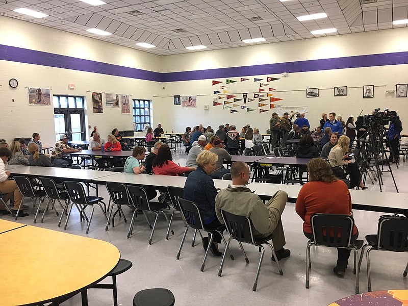 People wait in the Grundy County High School cafeteria for the school board to discuss the future of the school's 2017 football season.