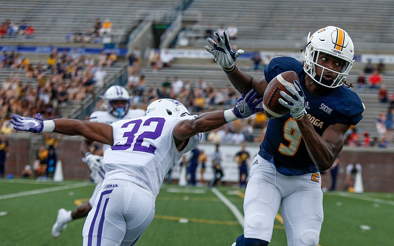 UTC wide receiver Alphonso Stewart (9) catches a pass ahead of Furman cornerback Darius Kearse (32) before running for a touchdown during the Mocs' home football game against the Furman Paladins at Finley Stadium on Saturday, Oct. 7, 2017, in Chattanooga, Tenn.