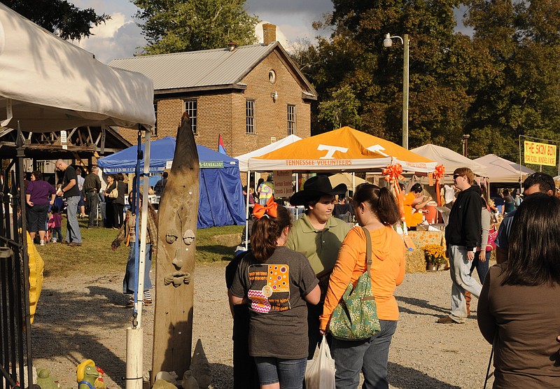 Colorful vendors' tents accent fall foliage at Ketner's Mill.