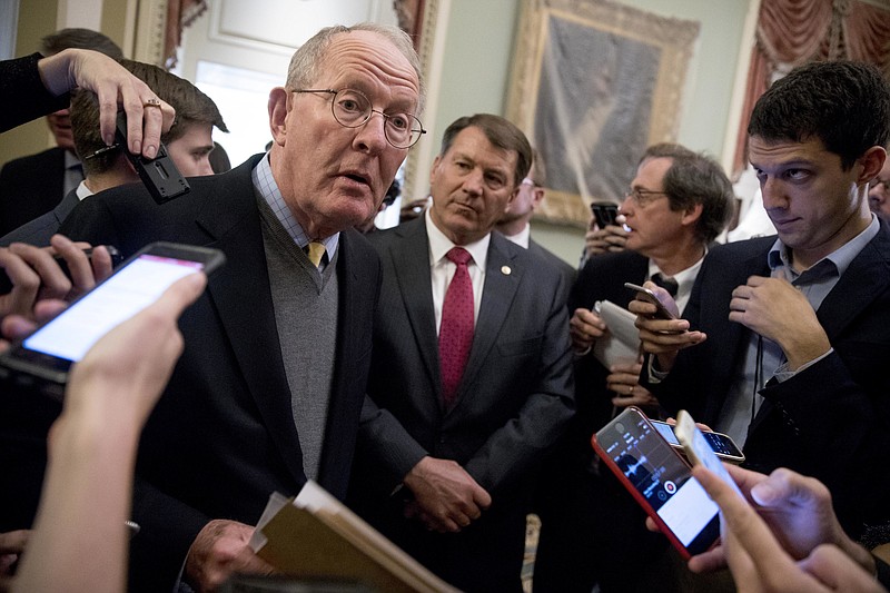 Sen. Lamar Alexander, R-Tenn., left, accompanied by Sen. Mike Rounds, R-S.D., center, speaks to reporters on Capitol Hill in Washington on Tuesday after Alexander and Sen. Patty Murray, D-Wash., said they have the "basic outlines" of a bipartisan deal to resume payments to health insurers that President Donald Trump has blocked. (AP Photo/Andrew Harnik)