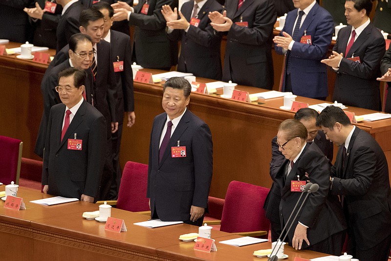 
              Chinese President Xi Jinping, center, stands with former Chinese President Hu Jintao, left, as former Chinese President Jiang Zemin is assisted into his seat at the opening ceremony of the 19th Party Congress held at the Great Hall of the People in Beijing, China, Wednesday, Oct. 18, 2017. Having bested his rivals, Chinese President Xi Jinping is primed to consolidate his already considerable power as the ruling Communist Party begins its twice-a-decade national congress on Wednesday.(AP Photo/Ng Han Guan)
            