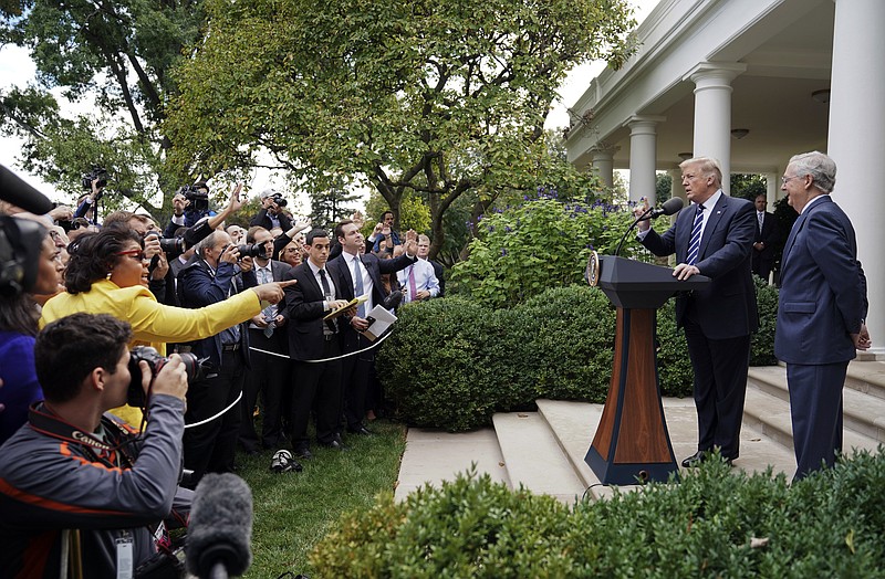 
              April Ryan, left, the Washington bureau chief for American Urban Radio Networks gestures as she asks questions to President Donald Trump and Senate Majority Leader Mitch McConnell of Ky., in the Rose Garden of the White House, Monday, Oct. 16, 2017. (AP Photo/Pablo Martinez Monsivais)
            