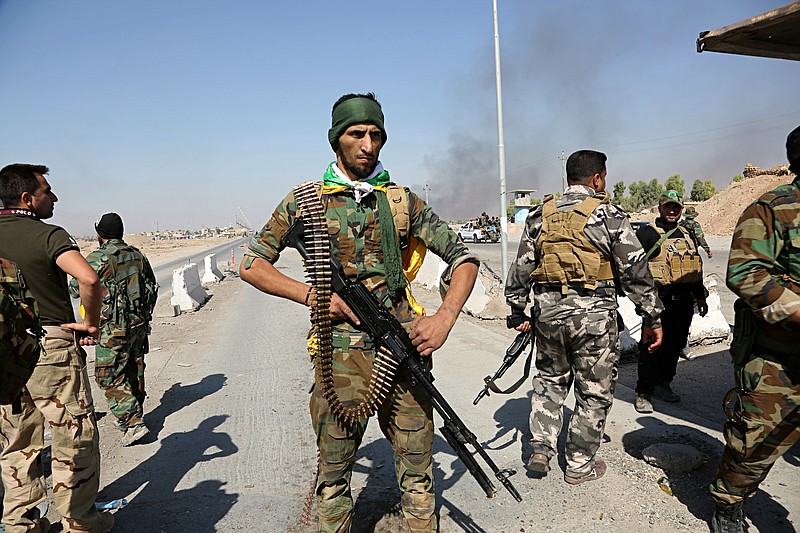 
              Iraqi security forces and Popular Mobilization Forces patrol in Tuz Khormato, that was evacuated by Kurdish security forces, 130 miles (210 kilometers) north of Baghdad, Iraq, Monday, Oct. 16, 2017. Two weeks after fighting together against the Islamic State, Iraqi forces pushed their Kurdish allies out of the disputed city of Kirkuk on Monday, seizing oil fields and other facilities amid soaring tensions over last month's Kurdish vote for independence. (AP Photo)
            