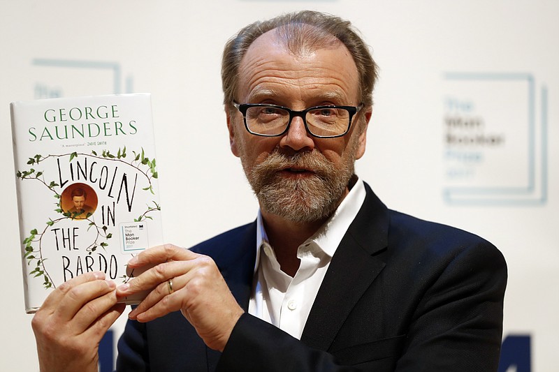 
              Author George Saunders of the United States with his book 'Lincoln in the Bardo' during a photocall with all six shortlisted authors of the 2017 Man Booker Prize for Fiction, in London, Monday, Oct. 16, 2017. The winner of the award will be announced Tuesday at a ceremony in London. (AP Photo/Kirsty Wigglesworth)
            