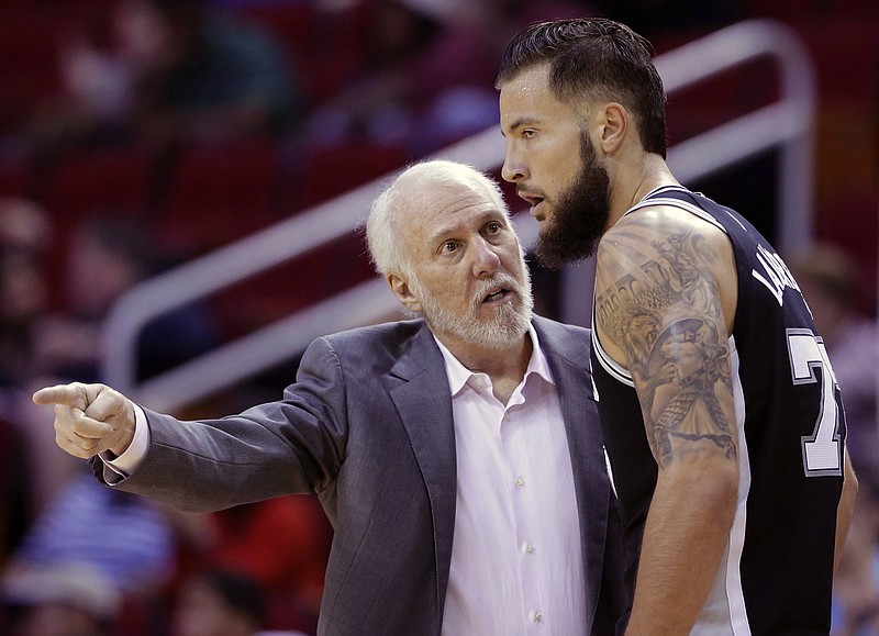 
              San Antonio Spurs head coach Gregg Popovich talks with San Antonio Spurs forward Joffrey Lauvergne (77) in the second half of an NBA preseason basketball game against the Houston Rockets Friday, Oct. 13, 2017, in Houston. (AP Photo/Michael Wyke)
            