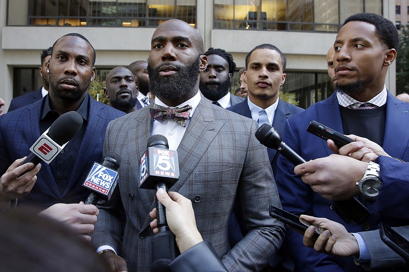 Former NFL football player Anquan Boldin, left, Philadelphia Eagles Malcolm Jenkins, center, and San Francisco 49ers Eric Reid, right, speak to the press outside the league's headquarters after meetings, Tuesday, Oct. 17, 2017, in New York. (AP Photo/Richard Drew)