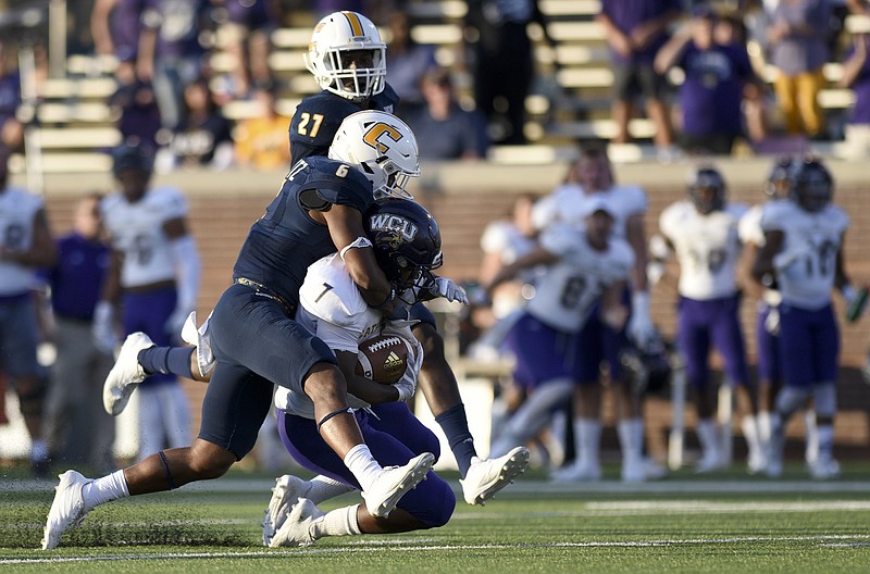 UTC defensive back C.J. Fritz tackles Western Carolina running back Corey Holloway during a SoCon game last month at Finley Stadium. The Mocs host The Citadel on Saturday, and stopping the Bulldogs' triple-option offense is a challenge UTC's defense has been busy preparing for.