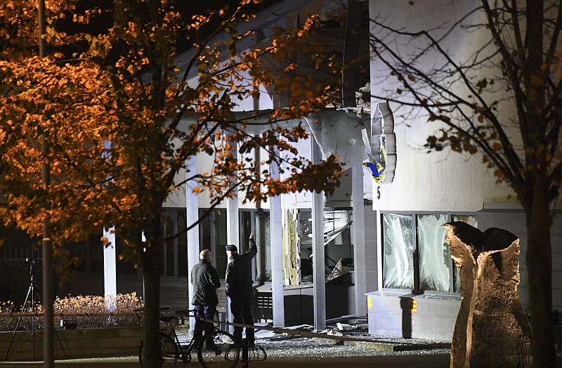 
              Police forensics work at the scene after a powerful explosion at the main entrance to a police station in Helsingborg, Sweden, Wednesday, Oct. 18, 2017. Swedish authorities said the explosion caused significant damage to the building. There have been no injuries and nobody has been arrested. (Johan Nilsson via TT News Agency via AP)
            