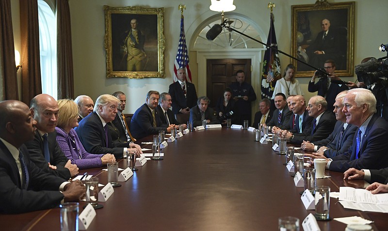 President Donald Trump, center left, meets with members of the Senate Finance Committee and members of the President's economic team in the Cabinet Room of the White House in Washington, Wednesday, Oct. 18, 2017. (AP Photo/Susan Walsh)