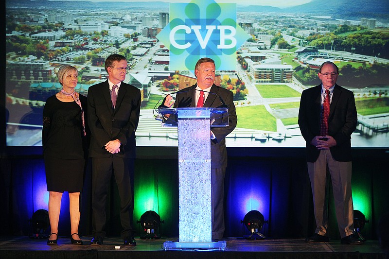 Staff file photo by Erin O. Smith / Darlene and Bob Doak stand on stage as Hamilton County Mayor Jim Coppinger and Jon Kinsey recognize Bob Doak and his wife during the 76th annual Meeting and Luncheon of the Chattanooga Convention and Visitors Bureau at the Chattanooga Convention Center on Sept. 20, 2017.