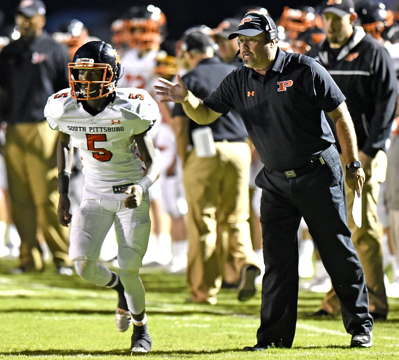 South Pittsburg football coach Vic Grider sends quarterback Jaylyn Hubbard in with the play during last month's rivalry victory against Marion County. This past Friday, the Pirates won for Grider's 192nd victory as a head coach, tying him with his later father Don, who also coached South Pittsburg.