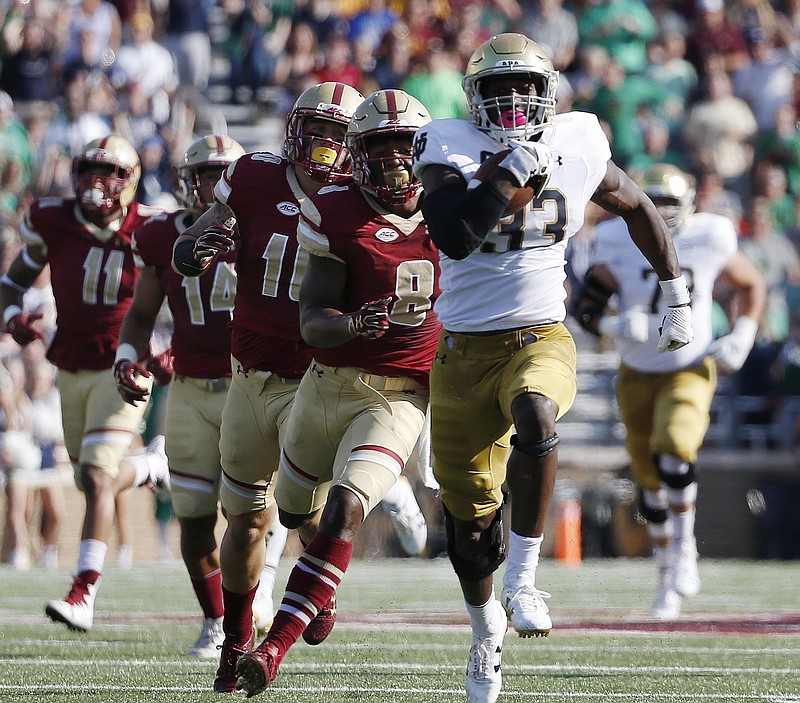 Notre Dame quarterback Brandon Wimbush breaks away from a pack of Boston College defenders, led by Will Harris, during their game last month in Boston. Wimbush has helped the Fighting Irish to a 5-1 record going into Saturday's game at Stanford. Boston College helped expose Louisville's defense during last week's 45-42 victory over the Cardinals.