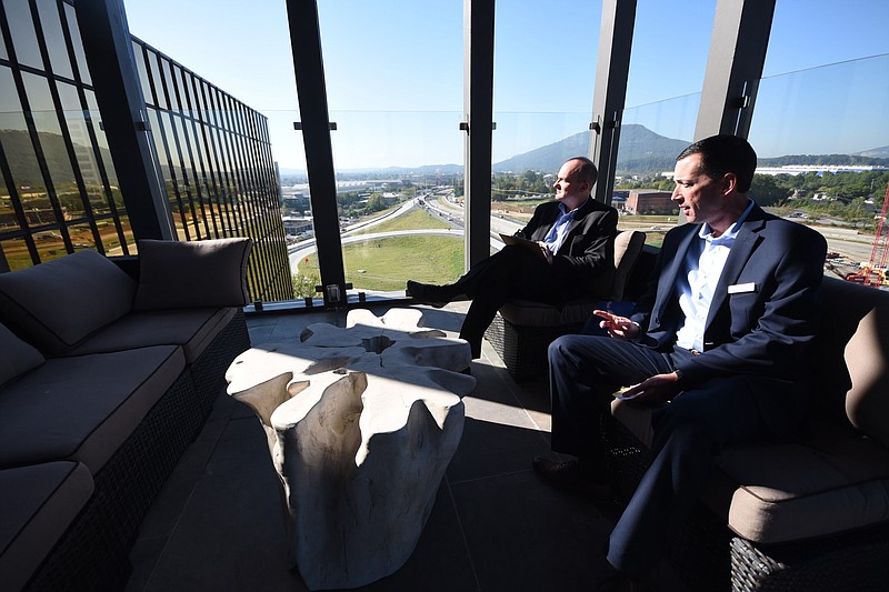 High atop the Westin Hotel in Chattanooga, Tom Underwood, left, Richard E. Pauley sit in the open-air bar/restaurant called Alchemy, on the 10th floor.