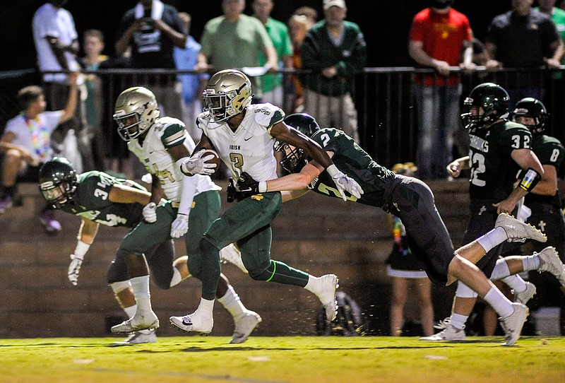 Notre Dame quarterback Cameron Wynn tries to break the tackle of Silverdale Baptist's Jarrett Clift during their game this month. Notre Dame can win the Division II-AA East Region title tonight with a win against Chattanooga Christian.