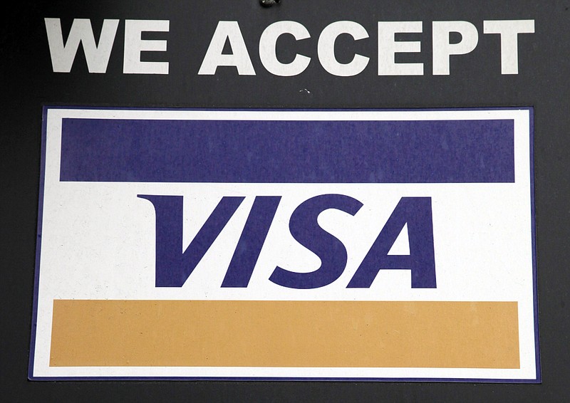 
              FILE - In this Jan. 21, 2015, file photo, a sign indicating Visa credit cards are accepted is posted at a New York business. Payment processing giant Visa is launching a platform to allow banks to integrate various types of biometrics, such as your fingerprint, face, voice, etc., into approving credit card applications and payments. It could lead to customers having to take a selfie to verify they actually made an online purchase or applied for a particular credit card. (AP Photo/Mark Lennihan, File)
            