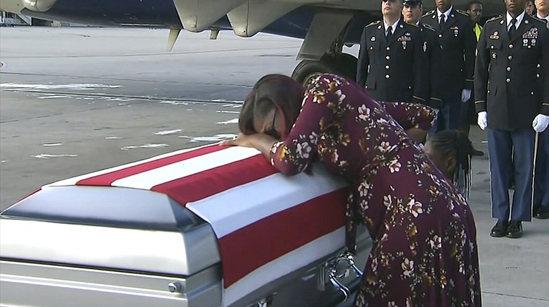 n this Tuesday, Oct. 17, 2017, frame from video, Myeshia Johnson cries over the casket of her husband, Sgt. La David Johnson, who was killed in an ambush in Niger, upon his body's arrival in Miami. President Donald Trump told the widow that her husband "knew what he signed up for," according to Rep. Frederica Wilson, who said she heard part of the conversation on speakerphone. In a Wednesday morning tweet, Trump said Wilson's description of the call was "fabricated." (WPLG via AP)