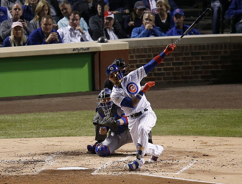 Chicago Cubs' Javier Baez watches his home run during the second inning of Game 4 of baseball's National League Championship Series against the Los Angeles Dodgers, Wednesday, Oct. 18, 2017, in Chicago. (AP Photo/Charles Rex Arbogast)