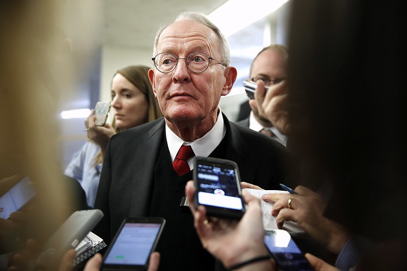 Sen. Lamar Alexander, R-Tenn., speaks to reporters as he heads to vote on budget amendments, Thursday, Oct. 19, 2017, in Washington. (AP Photo/Jacquelyn Martin)