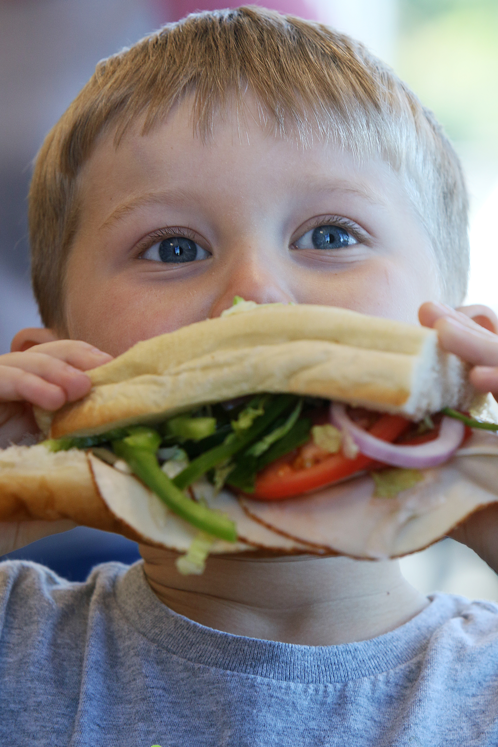 Owen Culberson, 4, of Ooltewah, Tenn., takes a bite out of his Subway sandwich that he made as a part of a Dynamic Dietetics class Monday, Oct. 16, 2017, at Subway in Cleveland, Tenn. Area registered dietitians are hosting five Share the Color workshops at various local Subway restaurants.