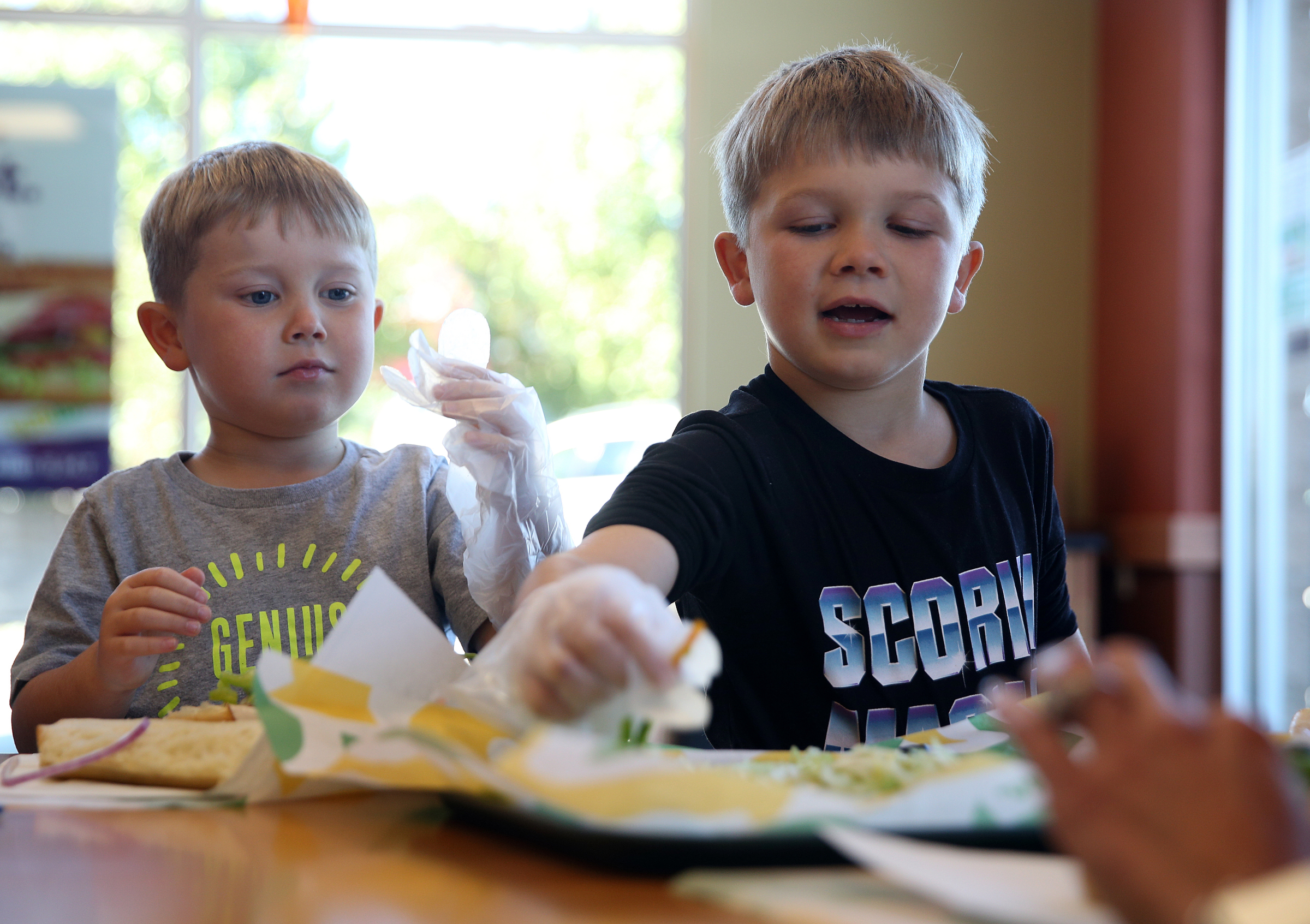 Owen Culberson, 4, and Noah Culberson, 7, of Ooltewah, Tenn., grab vegetables from a platter to pile on their sandwiches during a Dynamic Dietetics workshop Monday, Oct. 16, 2017, at Subway in Cleveland, Tenn. The two were excited to learn about different food groups from a local dietitian.