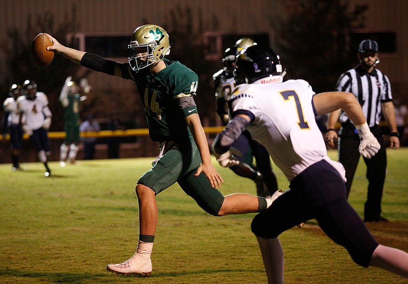 Notre Dame quarterback Landon Allen (14) makes a touchdown run ahead of Chattanooga Christian player Will Sabourin (7) during their prep football game at Notre Dame High School on Friday, Oct. 20, 2017, in Chattanooga, Tenn.