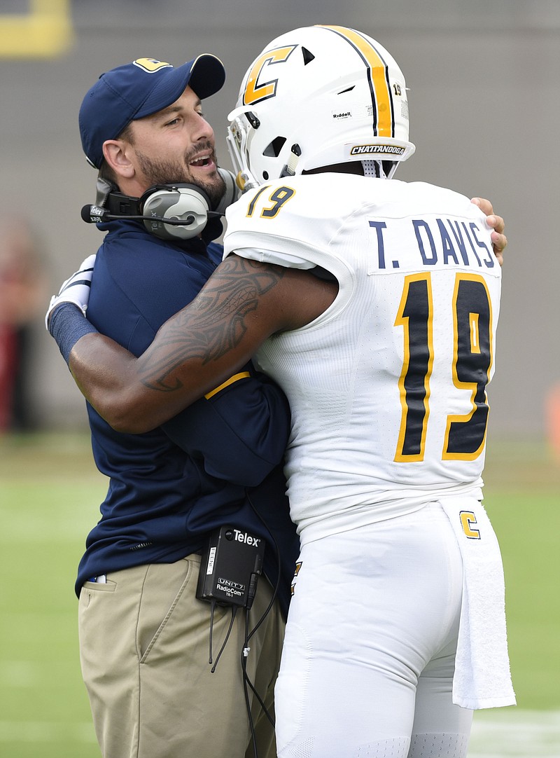 Linebacker coach Matt Feeney embraces Tae Davis (19) before the game.  The University of Chattanooga Mocs met the Jacksonville State Gamecocks in the Guardian Credit Union FCS Kickoff at the Carmton Bowl in Montgomery, Alabama on August 26, 2017. 