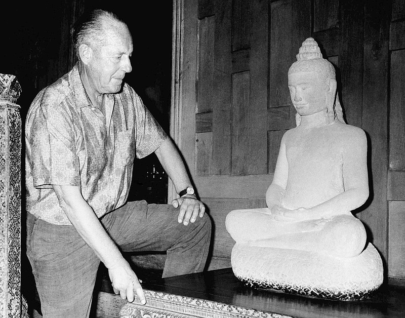 
              FILE - In this November 1966 file photo, American businessman Jim Thompson views a Buddha statue in Bangkok, Thailand. A new documentary is set to stir fresh debate over one of Asia’s most enduring mysteries: What happened to Jim Thompson, Thailand’s legendary silk king. (AP Photo/File)
            