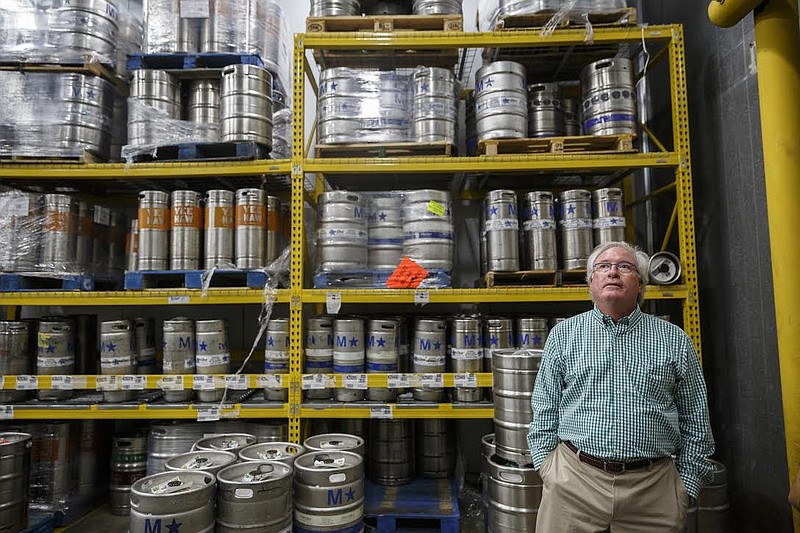 Blair Carter, Carter Distributing's owner and chief operating officer, stands near kegs of beer stacked in a cooler at the company's Broad Street warehouse on Wednesday, April 19, 2017, in Chattanooga, Tenn. He sold the family-owned business Friday for an undisclosed sum to a Knoxville company, Cherokee Distributing Co.