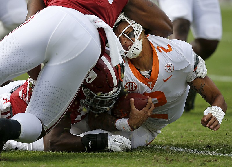 Tennessee quarterback Jarrett Guarantano is tackled by Alabama linebackers Anfernee Jennings, top, and Shaun Dion Hamilton during Saturday's 45-7 loss to the Crimson Tide, who tallied nine lost-yardage stops.