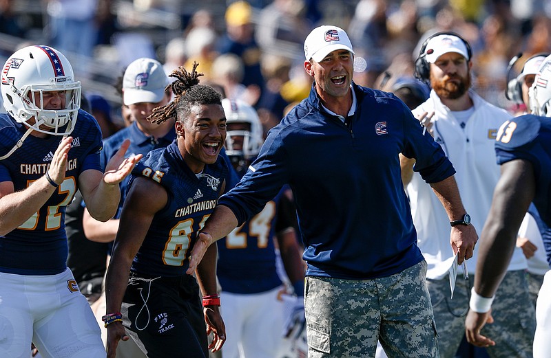 UTC head football coach Tom Arth congratulates players after a touchdown during the Mocs' home football game against the Citadel Bulldogs at Finley Stadium on Saturday, Oct. 21, 2017, in Chattanooga, Tenn.