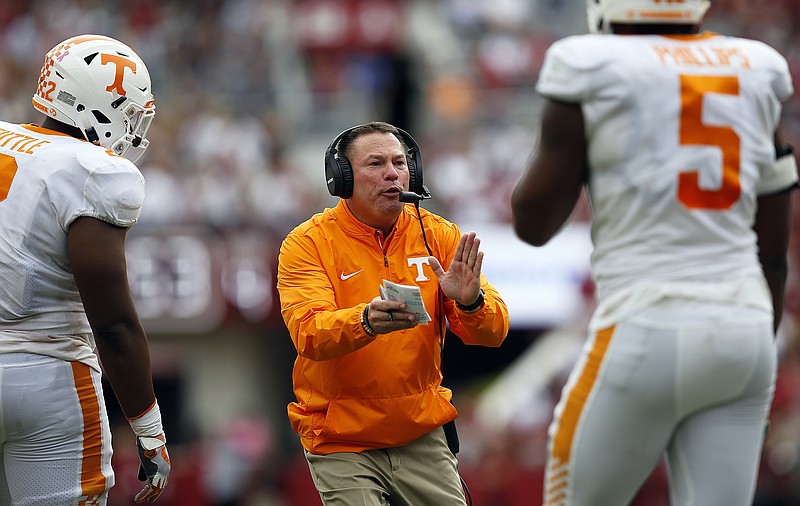 Tennessee head coach Butch Jones encourages his players as they run off the field during the first half an NCAA college football game against Alabama, Saturday, Oct. 21, 2017, in Tuscaloosa, Ala. (AP Photo/Brynn Anderson)