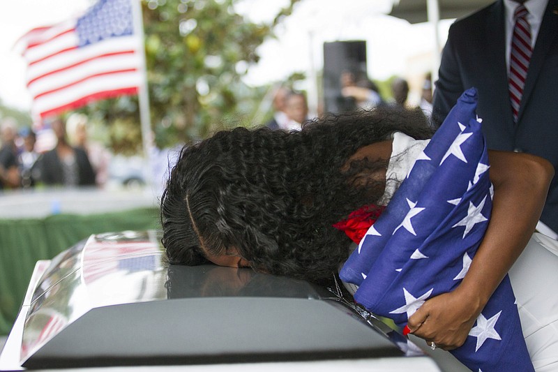 Myeshia Johnson kisses the casket of her husband, Sgt. La David Johnson during his burial service at Fred Hunter's Hollywood Memorial Gardens in Hollywood, Fla. on Saturday, Oct. 21, 2017. Johnson was among four soldiers killed in Niger on Oct. 4 when they were attacked by militants tied to the Islamic State. (Matias J. Ocner/Miami Herald via AP)