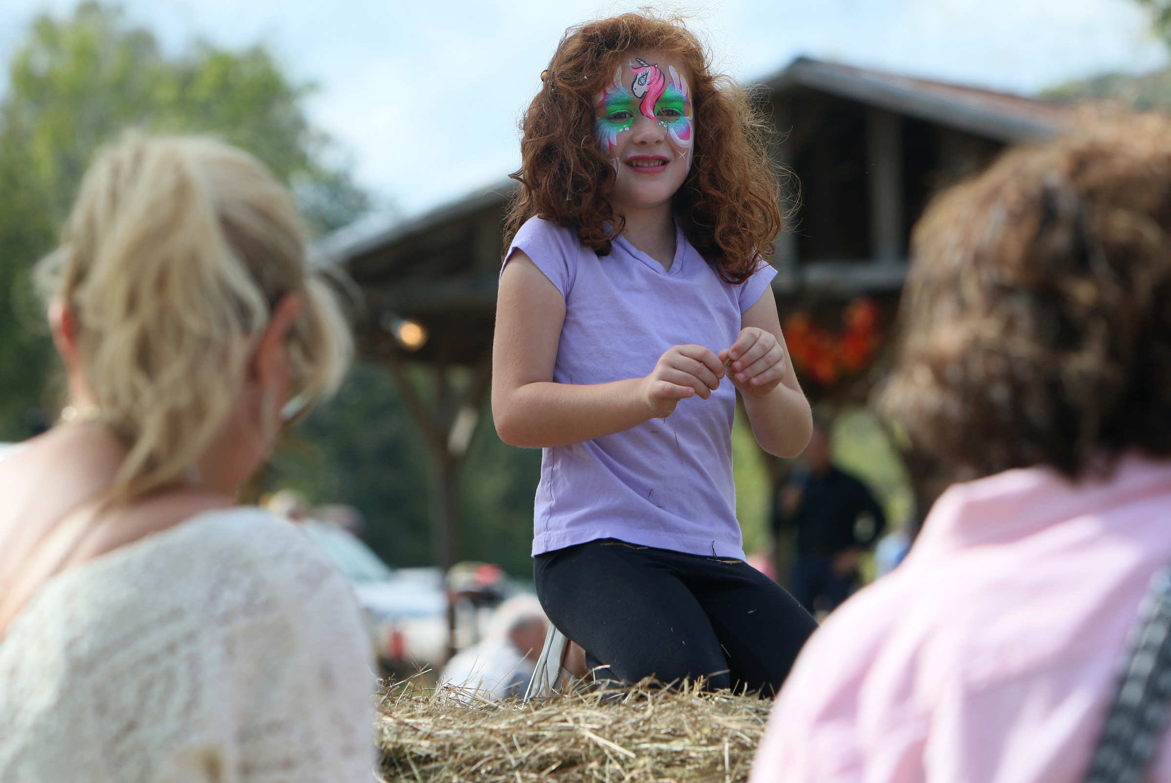 Drew Fuller, 5, of Soddy Daisy, Tenn., plays on top of a stack of hay bales during the 40th annual Ketner's Mill Country Arts Fair in Whitwell, Tenn., Sunday, Oct. 22, 2017. The fair was established in 1977 to help preserve the mill.