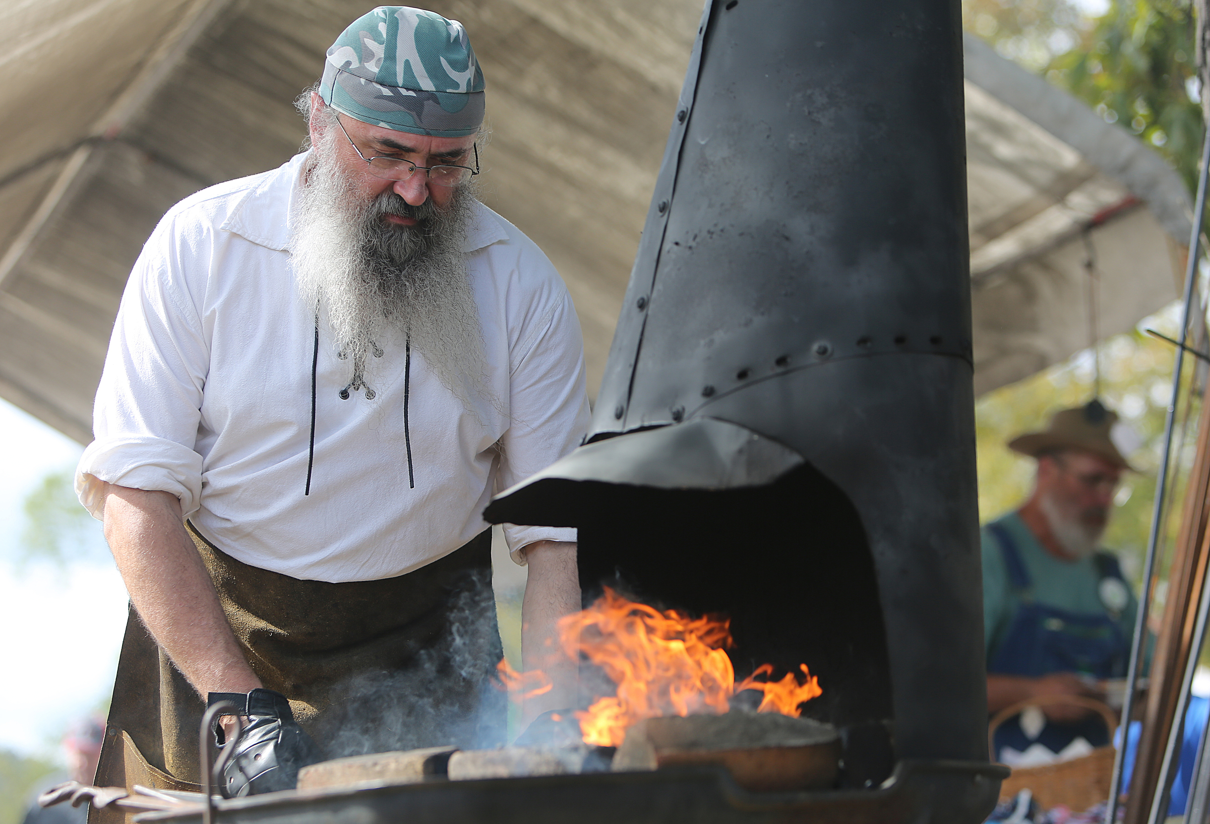 Jeff Clawson of the Choo Choo Forge uses a coal forge during a demonstration at the 40th annual Ketner's Mill Country Arts Fair in Whitwell, Tenn., Sunday, Oct. 22, 2017. The Choo Choo Forge booth had a variety of handmade items they have made on display including knives, wall hangers and more.