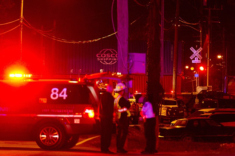 First responders stand at the scene of a train derailment involving dozens of rail cars in Knoxville, Tenn., Saturday, Oct. 21, 2017. (Calvin Mattheis/Knoxville News Sentinel via AP)