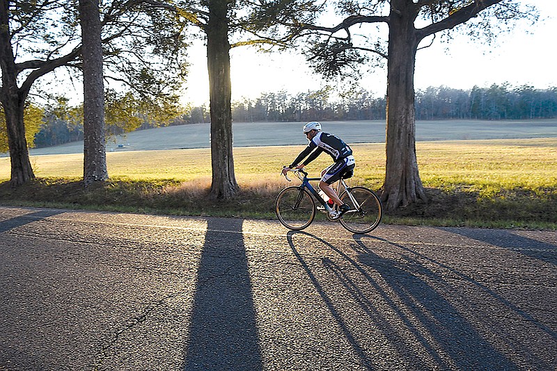 A cyclist casts long evening shadows as rides along the Dyer Field in Chickamauga National Military Park recently.