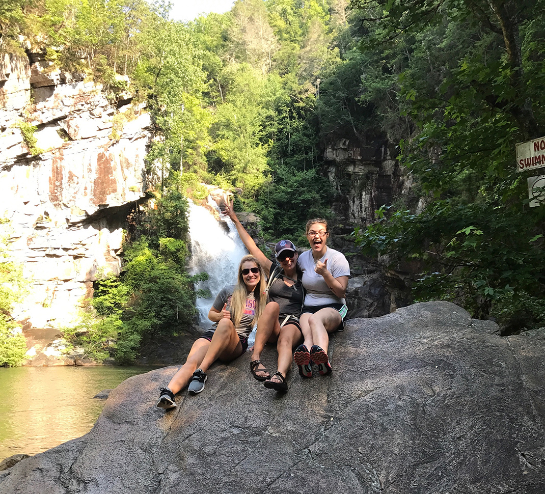 Three “Wild Women” celebrate the swimming opportunities found after hiking to the bottom of Tallulah Gorge in Georgia.