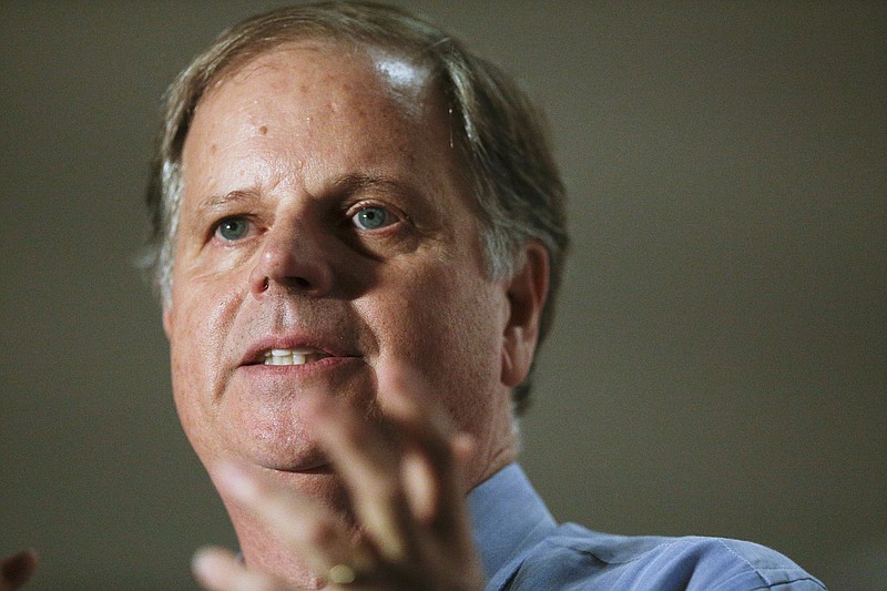 FILE - In this Tuesday, Oct. 3, 2017 file photo, Democrat Doug Jones speaks at a campaign rally for the race to fill Attorney General Jeff Sessions' former Senate seat, in Birmingham, Ala. Jones is betting that his underdog bid for the U.S. Senate gets a boost, at home and nationally, from his role in convicting two Ku Klux Klansmen who killed four young black girls in the 1963 bombing of Birmingham's 16th Street Baptist Church. (AP Photo/Brynn Anderson, File)