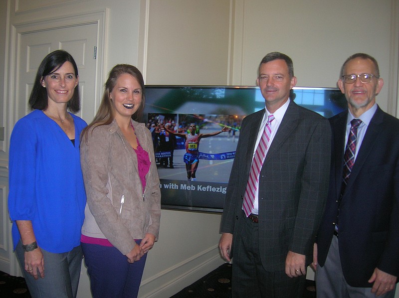 Leigh Ellington, second from left, associate executive director of the Cystic Fibrosis Foundation's Tennessee chapter based in Knoxville, joins Lee University staffers Vanessa Hammond, Bill Estes and Mike Hayes — longtime organizers of the Great Strides Walk and 65 Roses 5k in Cleveland — beside a video image of marathoner Meb Keflezighi, who has agreed to be part of the 2018 event.