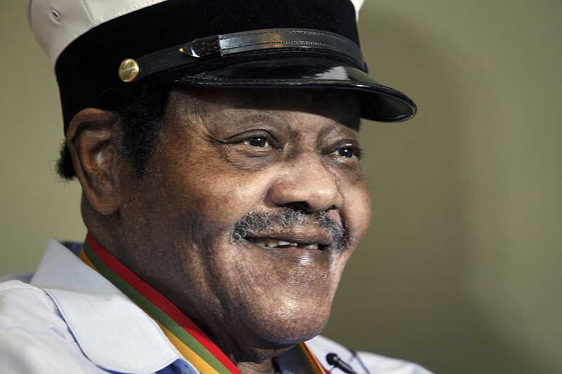  In this Dec. 20, 2013 file photo, legendary musician Fats Domino is named "Honorary Grand Marshall" of the Krewe of Orpheus, the star-studded Carnival club that traditionally parades the night before Mardi Gras in New Orleans. Domino, the amiable rock 'n' roll pioneer whose steady, pounding piano and easy baritone helped change popular music even as it honored the grand, good-humored tradition of the Crescent City, has died. He was 89. Mark Bone, chief investigator with the Jefferson Parish, Louisiana, coroner's office, said Domino died Tuesday, Oct. 24, 2017. (AP Photo/Doug Parker, File)