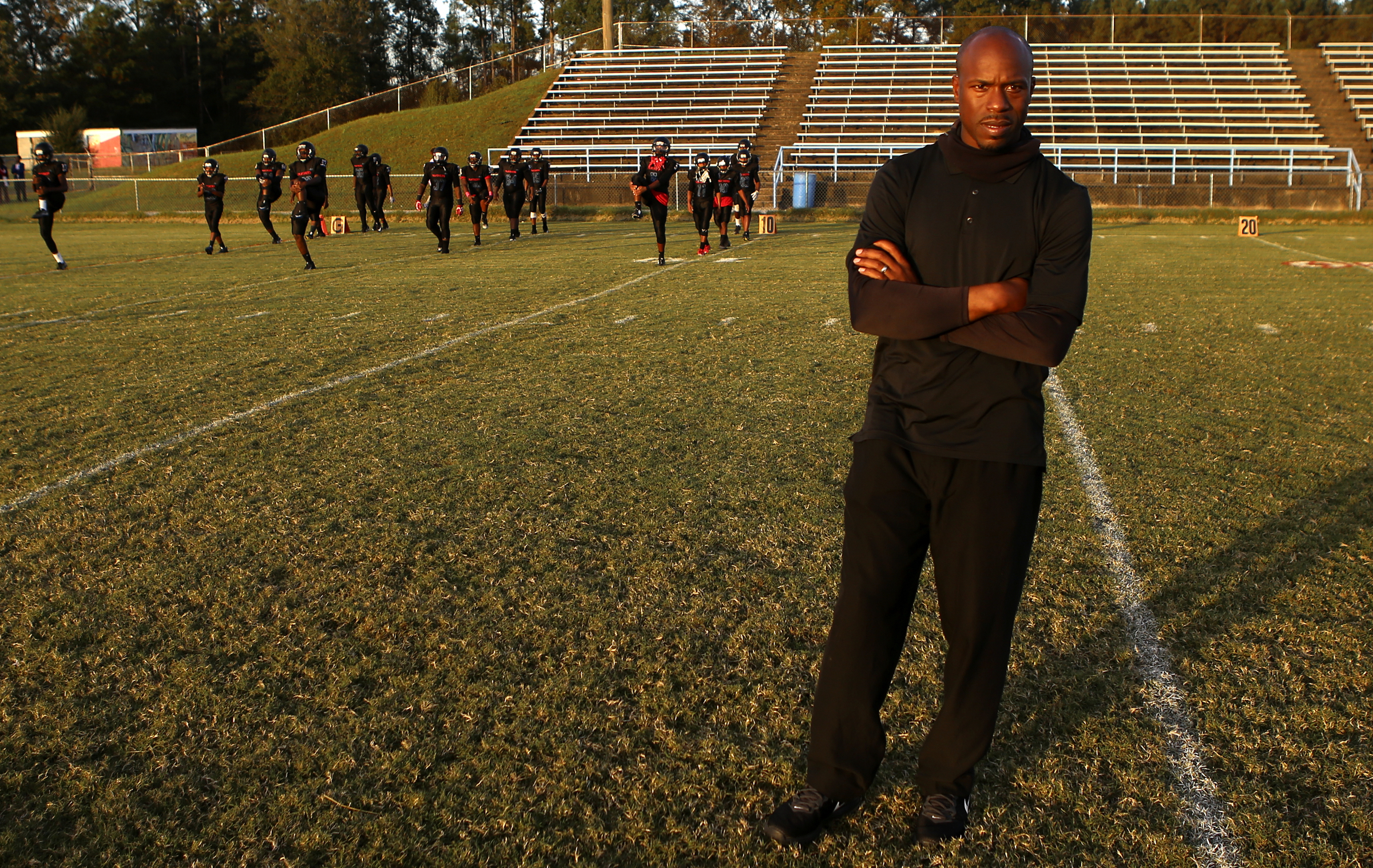 Brainerd head coach Tyrus Ward looks on as his team warms up before facing off against Tyner at Brainerd High School on Friday, Oct. 20, in Chattanooga, Tenn.