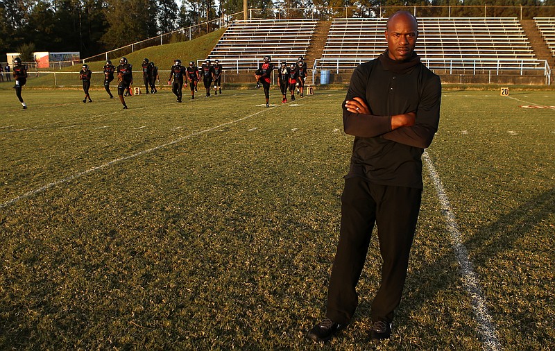 Brainerd head coach Tyrus Ward looks on as his team warms up before facing off against Tyner at Brainerd High School on Friday, Oct. 20, in Chattanooga, Tenn.