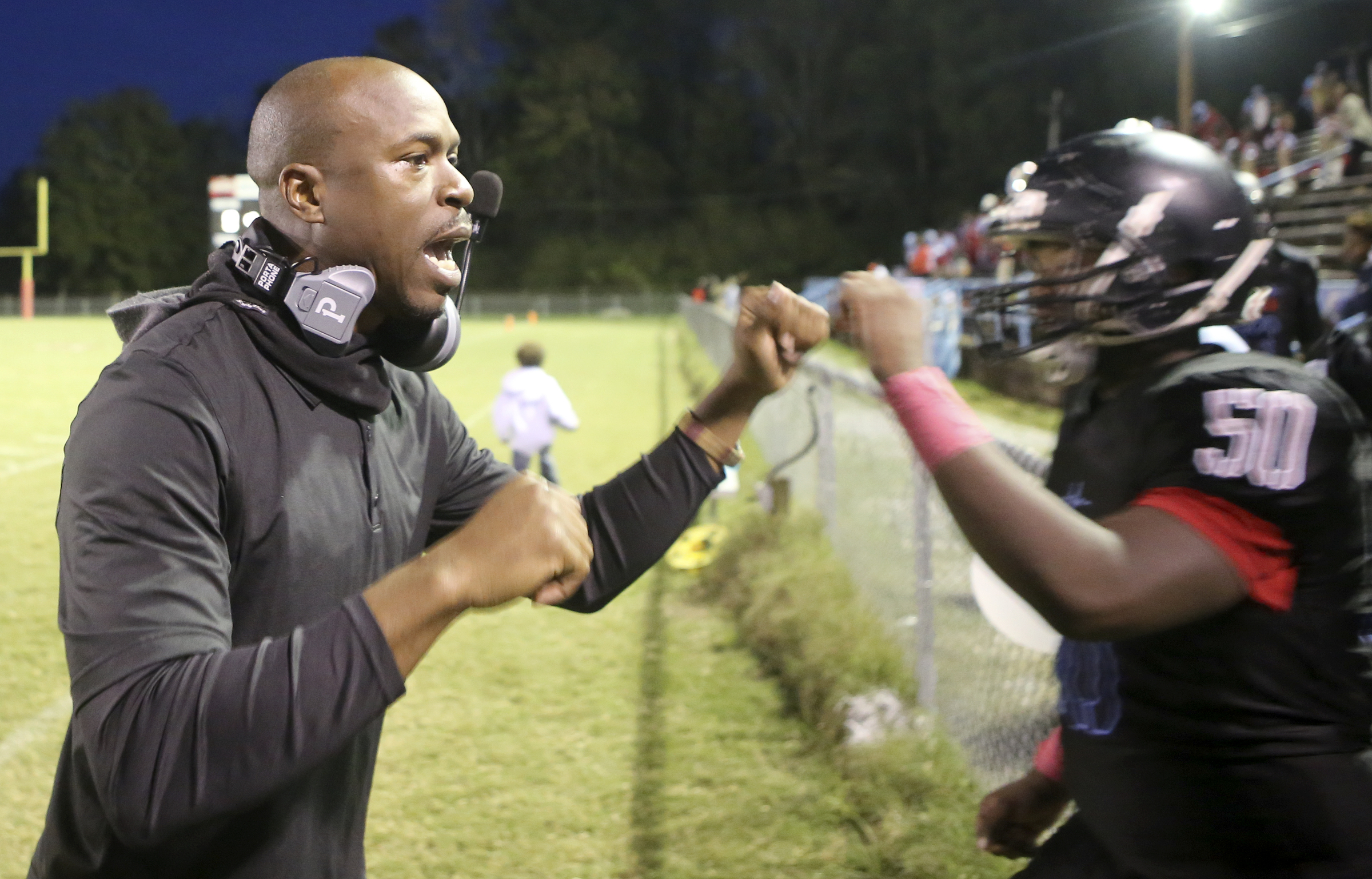 Brainerd head coach Tyrus Ward greets Sydney Stallworth (50) as he makes his way from the stands to the field for kickoff against Tyner at Brainerd High School on Friday, Oct. 20, in Chattanooga, Tenn.